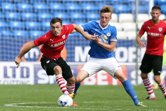 Posh skipper Chris Forrester battles for possession with Barnsley's Josh Scowen. Photo: Joe Dent/theposh.com.