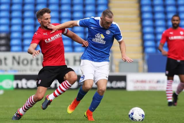 Marcus Maddison of Posh in action with Barnsley's Conor Hourihane. Photo: Joe Dent/theposh.com.