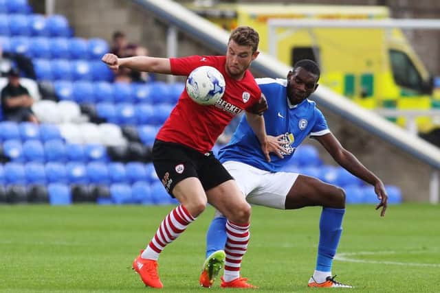 Posh right-back Hayden White tries to get the ball off Barnsley striker Sam Winnall. Photo: Joe Dent/theposh.com.
