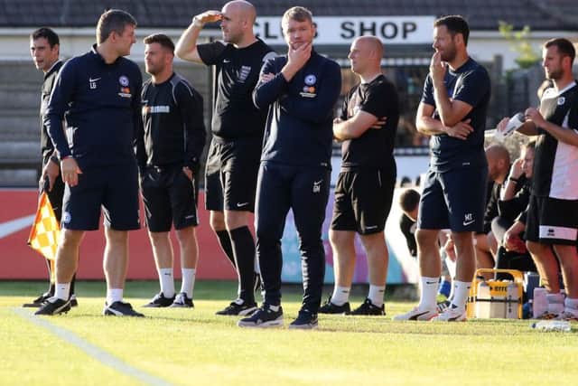 Posh manager surveys the scene ain a friendly at Boreham Wood. Photo: Joe Dent/theposh.com.