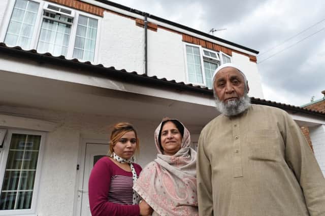 Mr Bakhsh Elahi, Mrs Zanaib Bibi and daughter Tayyaba Bibi outside their home at Atkinson Street which was subject to an arson attack EMN-160108-193503009