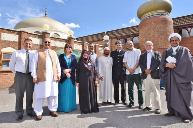 Imams Molana Kassamali and Sheikh Shahnawai Mahdavi with Police ACC Naveed Malik with guests at the Burton St Mosque open day EMN-160718-090021009