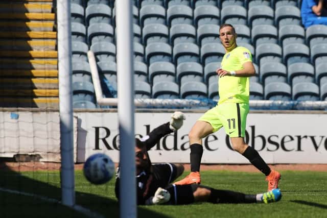Man-of-the-match Marcus Maddison scores for Posh at Rochdale. Photo: Joe Dent/theposh.com.
