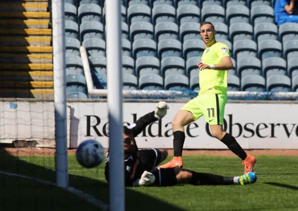 Man-of-the-match Marcus Maddison scores for Posh at Rochdale. Photo: Joe Dent/theposh.com.