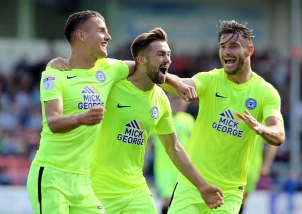 Posh midfielder Gwion Edwards (centre) celebrates his winning goal for Posh at Rochdale with Tom Nichols (left) and Andrew Hughes (right). Photo: Joe Dent/theposh.com.