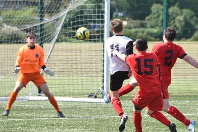 Tom Randall (11) scores for Netherton against Pinchbeck. Photo: David Lowndes.