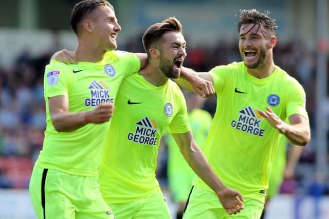 Gwion Edwards (centre) celebrates his wining goal for Posh at Rochdale with Tom Nichols (left) and Andrew Hughes. Photo: Joe Dent/theposh.com.