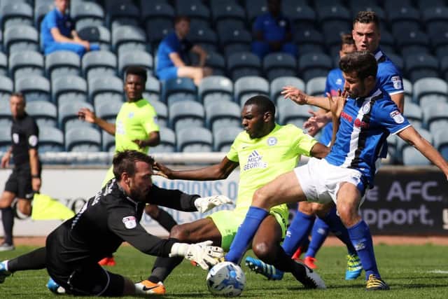 Hayden White (centre, yellow) played well for Posh against Rochdale. Photo: Joe Dent/theposh.com.