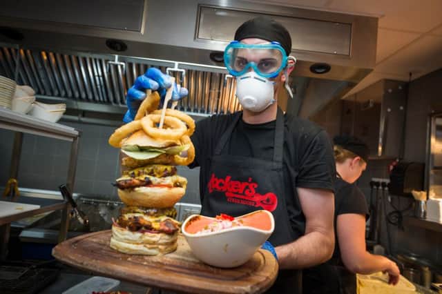 Jan Szymula age 28 head chef puts finishing touches to the hot burger.