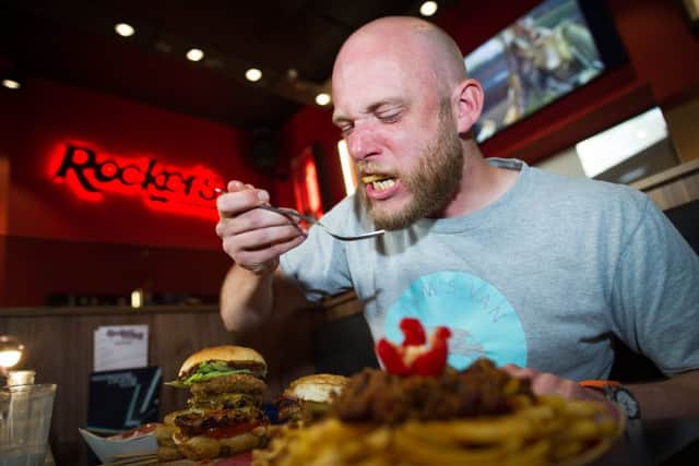 Rob Radcliffe age 36 takes on the hot burger challenge at Rocker's Stake House in Cambridge.