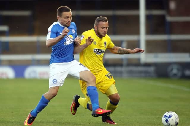 Posh striker Paul Taylor battles for possession with Dean Parrett of AFC Wimbledon. Photo: Joe Dent/theposh.com.