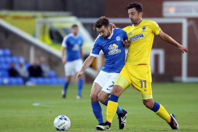 Posh midfielder Gwion Edwards battles against AFC Wimbledon winger Chris Whelpdale. Photo: Joe Dent/theposh.com.