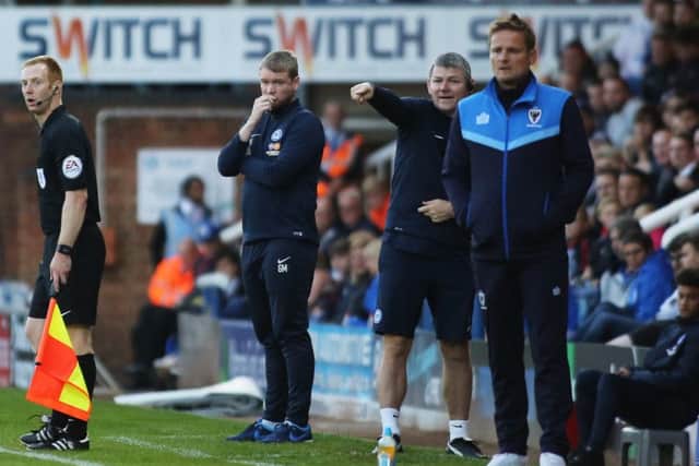 Rival managers Grant McCann and Neil Ardley watch an exciting EFL Cup tie unfold. Photo: Joe Dent/theposh.com.