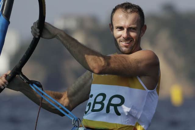 Nick Dempsey smiles after crossing the finish line.