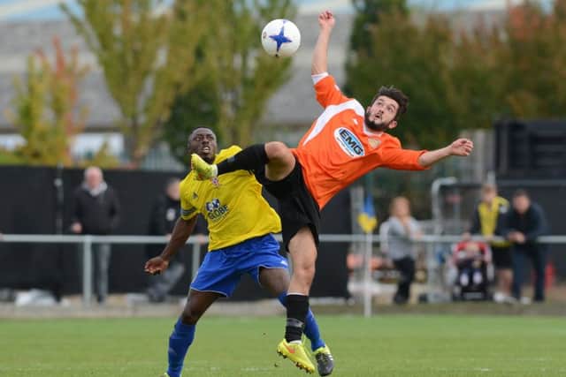 Dan Banister (orange) scored for Peterborough Sports at Wisbech.