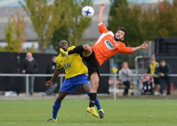Dan Banister (orange) scored for Peterborough Sports at Wisbech.