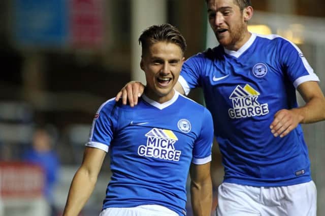 Posh striker Tom Nichols celebrates his winning goal against AFC Wimbledon with Jack Baldwin.