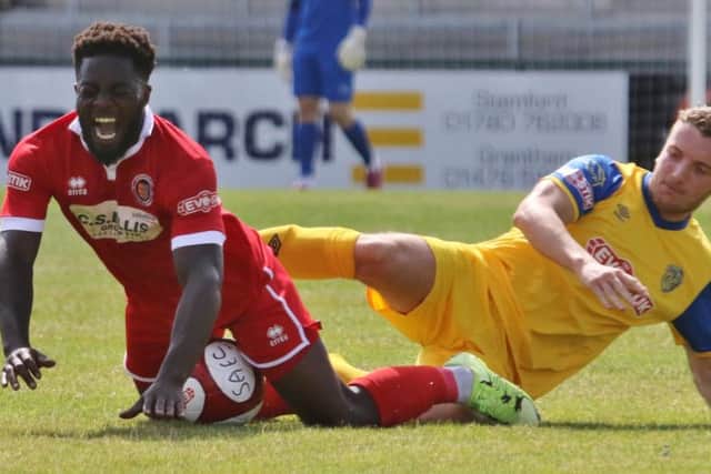 Action from Stamford AFC (red) v Spalding United in the Lincs Senior Trophy. Photo: Geoff Atton.