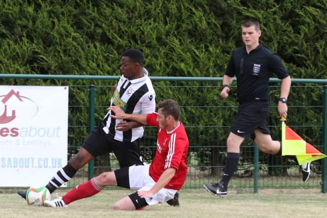 Jezz Goldson-Williams (stripes) in action for Peterborough Northern Star against Rothwell Corinthians. Photo: Tim Gates.