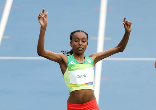 Almaz Ayana celebrates winning the women's 10,000m.