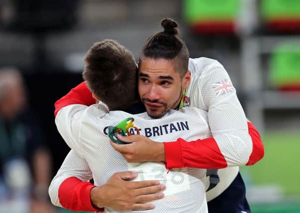 Louis Smith and Max Whitlock embrace after the men's pommel horse final.