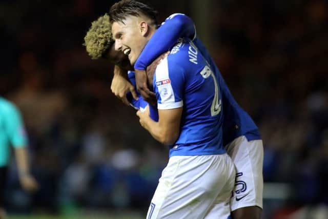 Tom Nichols celebrates scoring his goal with team-mate Jermaine Anderson. Picture: Joe Dent