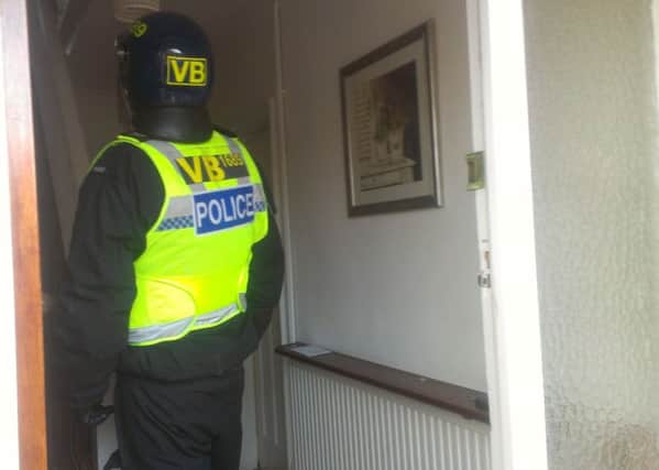Police force entry to the house in Newark Avenue this morning during a series of 10 drug related raids