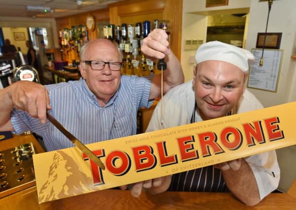 Conservative Club chairman Les Smith and head chef Rob Jarvis with the giant Toblerone weighing 4.5kg to be raffled in aid of the Free Kicks Foundation EMN-160817-003250009
