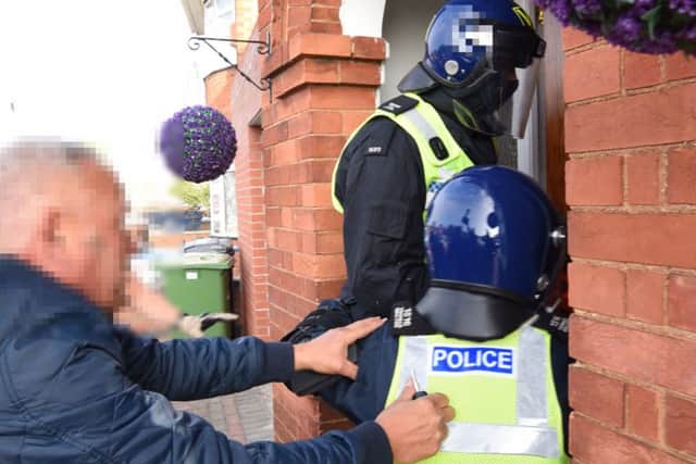Police force entry to the house in Newark Avenue this morning during a series of 10 drug related raids