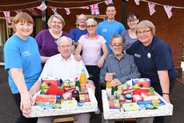Volunteers from Tesco Werrington at Martin Court presenting food parcels to residents who had their disabled motor scooters stolen William Oak and Norman Cooke EMN-160823-175728009
