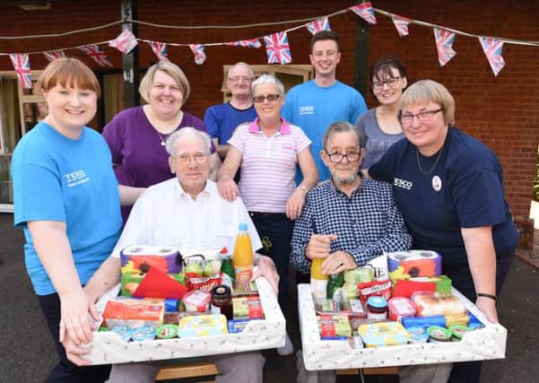 Volunteers from Tesco Werrington at  Martin Court presenting food parcels to residents who had their disabled  motor scooters stolen William Oak and Norman Cooke EMN-160823-175728009