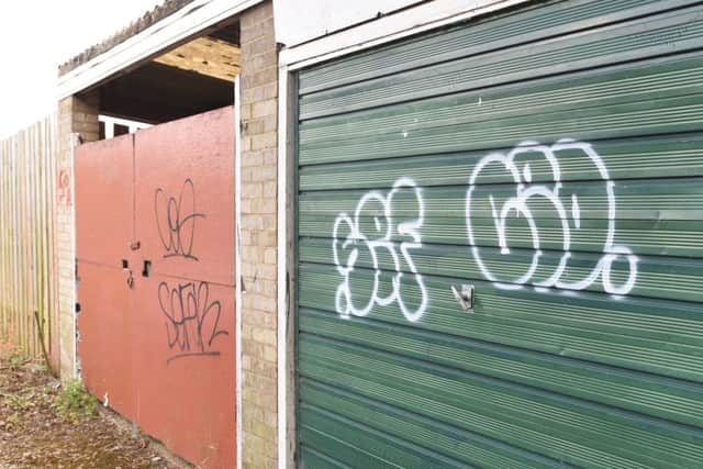 Graffiti at the side and rear of the shopping parade at Church Drive , Orton Waterville EMN-160818-172747009