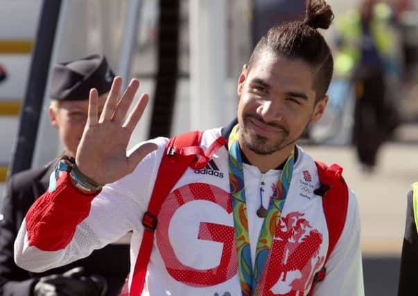 Great Britain's Louis Smith with his silver medal at Heathrow Terminal 5. Photo credit: Steve Parsons/PA Wire