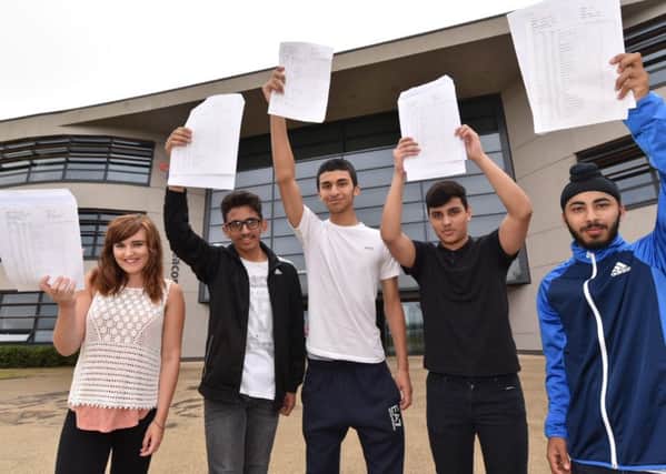 GCSE pupils at Thomas Deacon Academy with their results