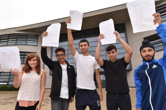 GCSE pupils at Thomas Deacon Academy with their results