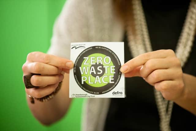 Green Business Officer Kim Coley pictured with the new Zero Waste Place stickers at the launch of PECT's Investors in the Environment business accreditation scheme at the Materials Recycling Facility in Fengate, Peterborough. ENGEMN00120111017100620
