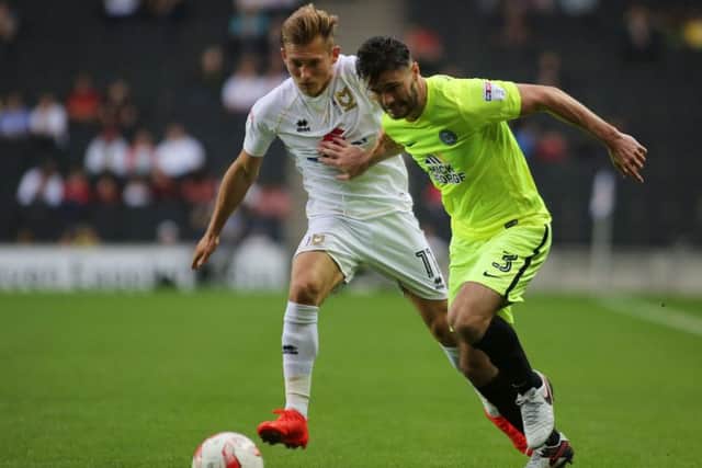 Posh goal-scorer Andrew Hughes battles with George C Williams of MK Dons. Photo: Joe Dent/theposh.com.