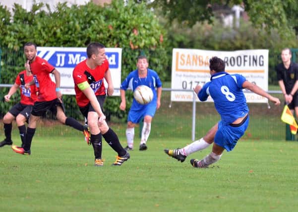 Action from Bourne's (blue) 2-1 win over Irchester.