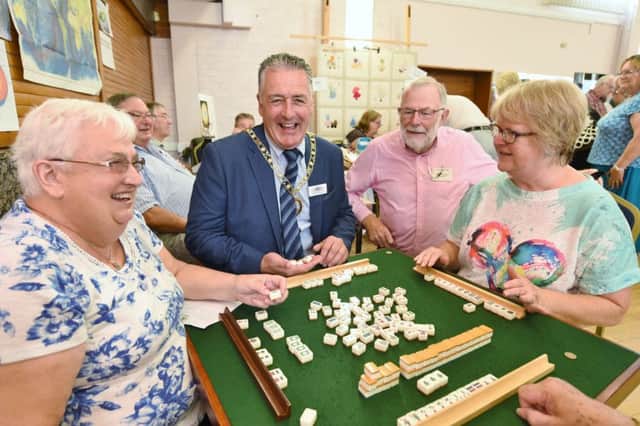 U3A fair at the Fleet Complex.  Christine Saunders, Julie Wareham and Brian Keegan with the Mayor David Sanders trying out a Chinese board game EMN-160825-121542009