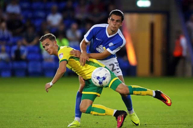 Posh midfielder Callum Chettle tackles James Maddison of Norwich City. Photo: Joe Dent/theposh.com.