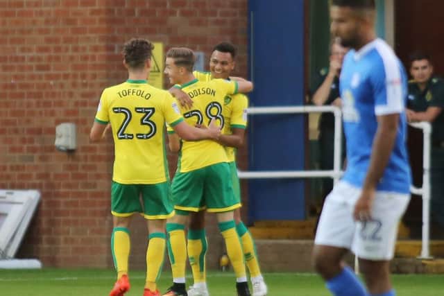 Norwich celebreate the opening goal while Posh midfielder Adil Nabi looks dejected. Photo: Joe Dent/theposh.com.