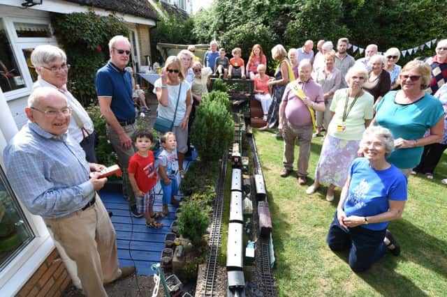 Keith Richardson (front left)  with guests at his Little Puffers open garden at Apsley Way, Longthorpe. EMN-160828-220946009