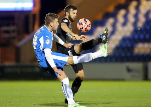 George Moncur in action for Colchester against Posh.