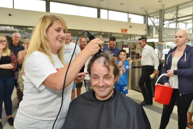 British Rail train drivers who are having their heads shaved by hairdresser Hayley Hindle in aid of Katie Rickett Pictured is Paul Andrews. EMN-160831-214029009