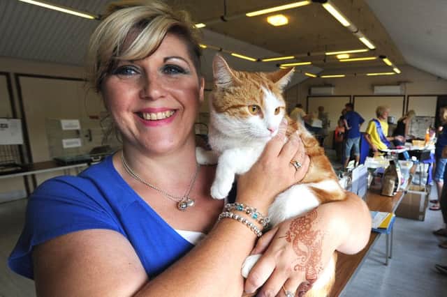 Cats Protection League volunteer Sheridan Gaunt holds unwanted pet Arthur, during a rehoming event at Loxley Community Centre, Werrington. ENGEMN00120130408173222