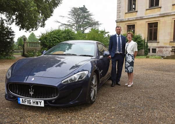 Tim Edwards, of Marshall Maserati, with Judith Wojtowicz, of Sue Ryder Thorpe Hall charity, with  a Maserati GranTurismo Sport.