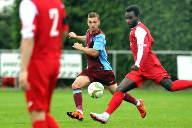 Action from Gresley's (red) 6-2 win at Deeping Rangers in the FA Cup. Photo: Tim Wilson.