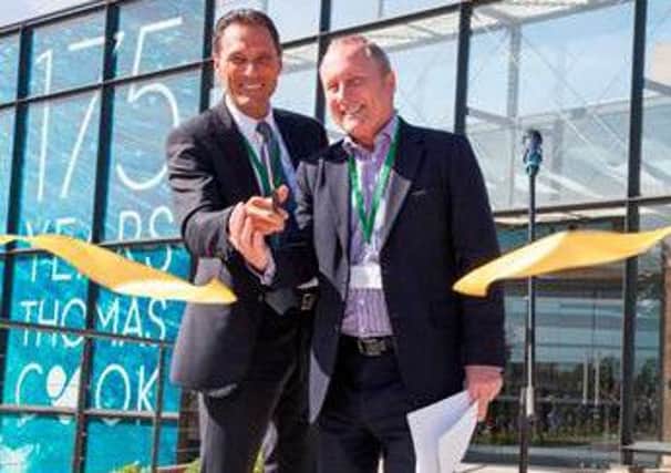 Peter Fankhauser cuts the ribbon with Chris Mottershead to open Thomas Cooks new offices.