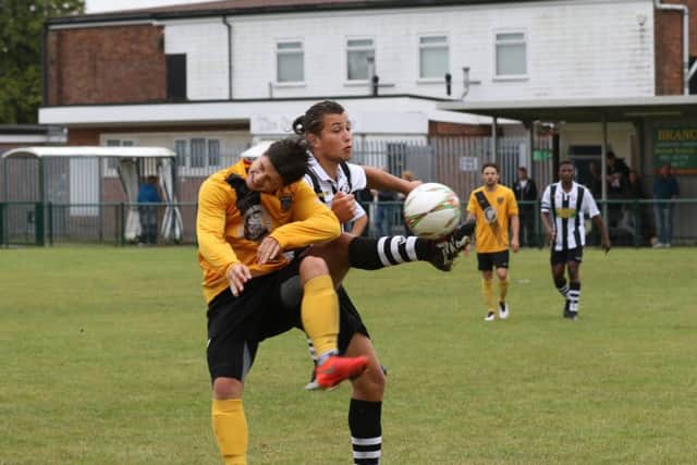 Levi Wright (stripes) in action for Peterborough Northern Star against Harborough Town. Photo: Tim Gates.