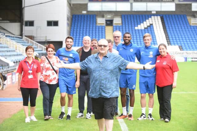 Marathon man Chris York with Debbie Beales and Iona McAllister from CPFT with Posh players Brad Inman, Hayden White and Chris Forrester and friends during his first lap of the Posh Ground. EMN-160709-155906009